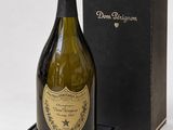 an old bottle of champagne in a black box with a black lid
