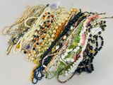 many different types of beaded bracelets on a white surface