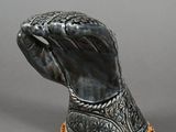 an image of a silver and gold figurine of a horse ' s head
