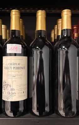 several bottles of wine are lined up on a shelf in a store