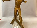 bronze statue of a man on skis on a marble base