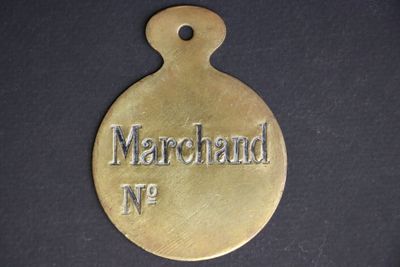 a close up of a brass medal with the name of a man