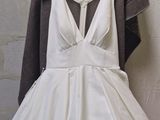 a picture of a wedding dress hanging on a hanger