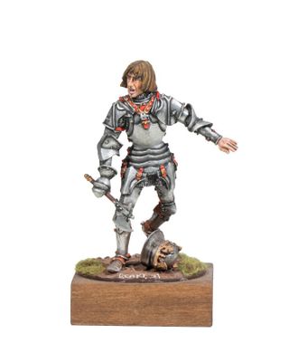 the figurine is standing on a wooden base with a sword