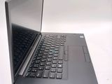a laptop computer sitting on a table with a keyboard