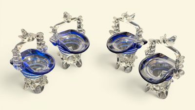 three blue glass vases sitting on top of a table next to each other