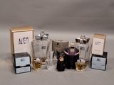 a lot of different perfumes and perfume bottles on the table