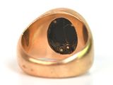 an image of a gold ring with a black stone in the center