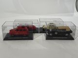 three model cars are in a display case on a white surface