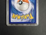 a close up of a pokemon card in a plastic holder on a table