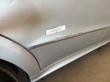 a silver car with a sticker on the side of it