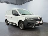 the white van is parked in a large room with a black floor