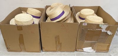 three boxes of straw hats are stacked on top of each other