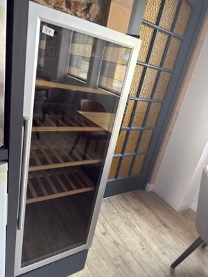 a wine cooler in the corner of a room