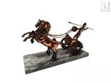 statue of a horse drawn carriage with two men on it