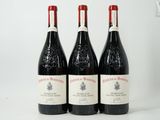 three bottles of wine sitting on top of a white table
