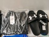 several pairs of black and white slippers and a pair of blue shorts and a pair of black and white slippers