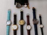 a lot of watches that are sitting on a table