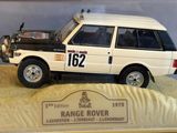 a model of a white land rover in a display case