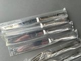 five knives in the package on the table