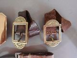 several different types of leather belts and a knife on a table