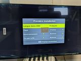 a flat screen tv sitting on top of a stand