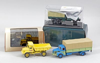 trois camions jouets assis l'un à côté de l'autre
