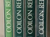 three books are stacked on top of each other on a shelf