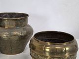 two vases sitting next to each other on a table