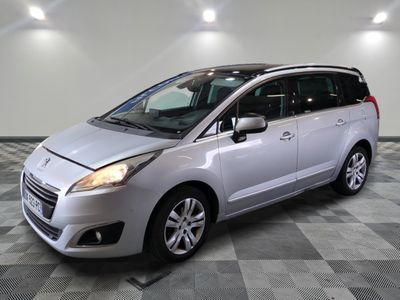 a picture of a silver minivan parked in a garage