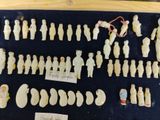 a lot of figurines on display in a display case