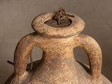 an old vase with a flower in it sitting on a table