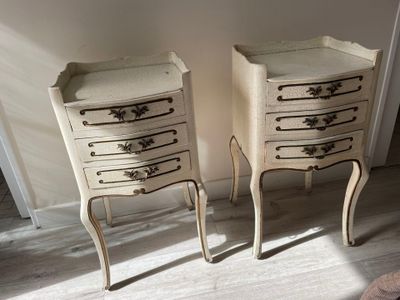 two white chests with drawers on them in a room