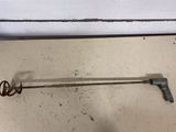 a metal object that is on the floor next to a wall