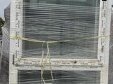 a white refrigerator sitting on a pallet with plastic wrapped around it