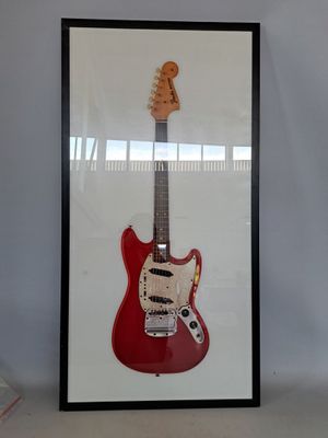 framed photograph of a red electric guitar in a black frame