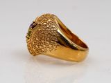 an image of a gold ring with a purple stone in the center