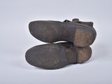 pair of brown leather shoes on white surface with white background