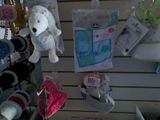 many stuffed animals hanging on the wall in the store