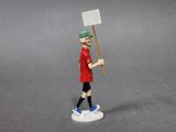 figurine of a man with a sign on a white base