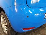 a close up of a blue car with a sticker on it