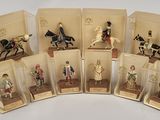 plusieurs figurines représentant des personnes à cheval, alignées les unes à côté des autres