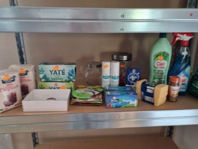 a shelf that has many different types of cleaning products on it