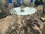 a table and chairs that are outside in the sun