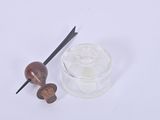 a glass of water and a wooden spoon on a white surface