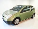 a picture of a small green car in a white room