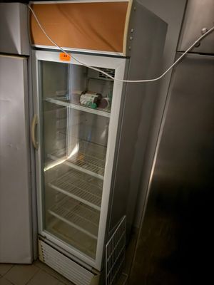 a refrigerator that has a door open in a kitchen