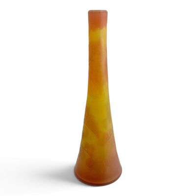 orange and yellow vase on a white surface with a white background