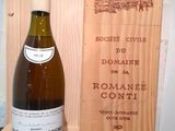 a bottle of wine sitting next to a wooden box