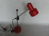 a red lamp that is sitting on a table